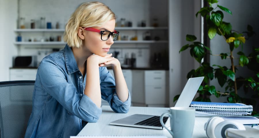 Young professional using laptop in home workspace